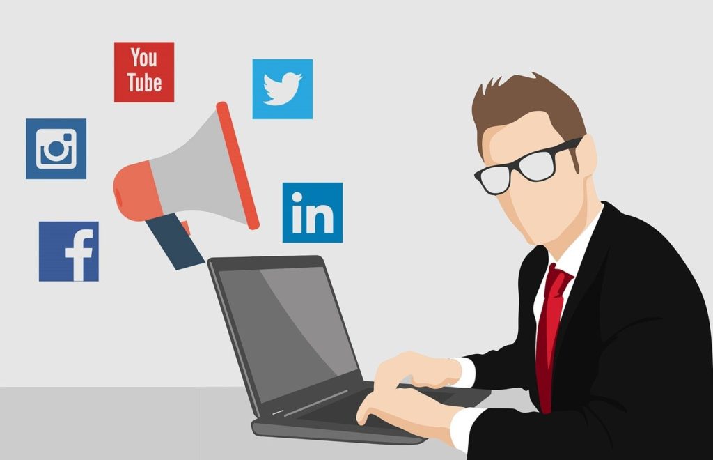 Illustration of man typing on laptop with social media icons in air